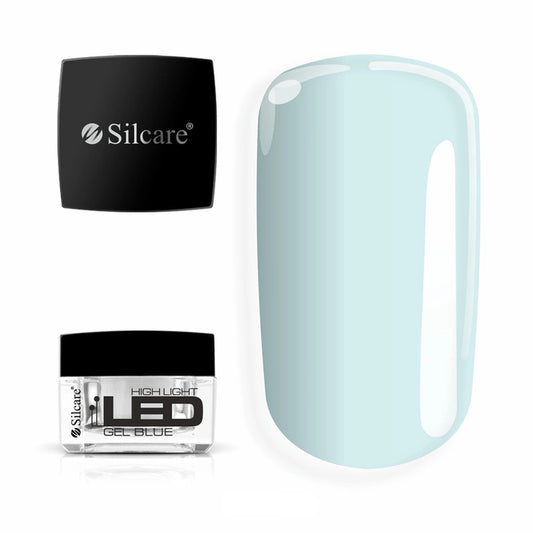 Jar of High Light LED Blue Builder Gel (15g), set next to a large nail tip, displaying the clear formula with a subtle blue tint to neutralize yellowing.
