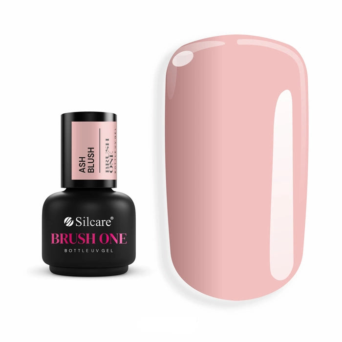 Brush One Bottle Gel (15g) in Ash Blush, set next to a large nail tip, displaying the opaque, cool-toned dusty rose beige color sample.