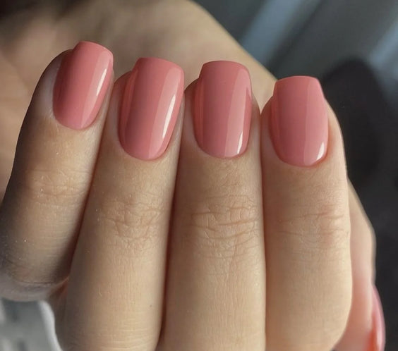 Smooth, full coverage manicure in the opaque Nothing Special shade (warm terracotta pink), achieved using Base One Builder Gel in a Bottle.