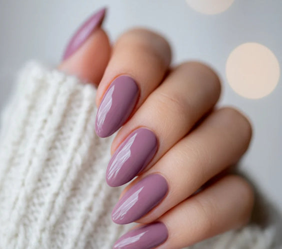 Nails finished with Base One Brush One Bottle Gel (15g) in Urban Storm, displaying a smooth, dark dusty pink manicure with subtle violet undertones for an elegant look.