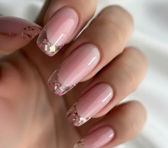 Woman's hand displaying a nail art design finished with Base One Violet UV builder gel (15g), showing the clear, non-yellowing, high-gloss encapsulation.