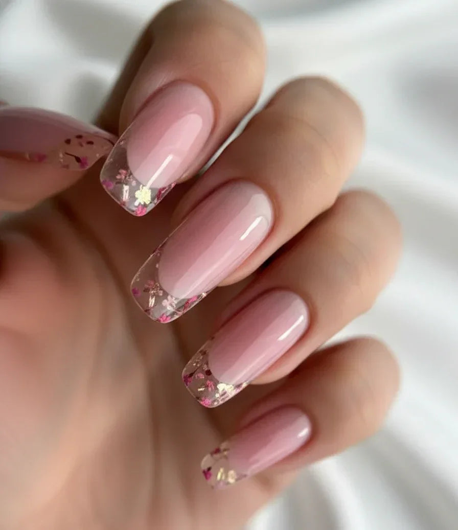 Woman's hand displaying a nail art design finished with Base One Violet UV builder gel (15g), showing the clear, non-yellowing, high-gloss encapsulation.