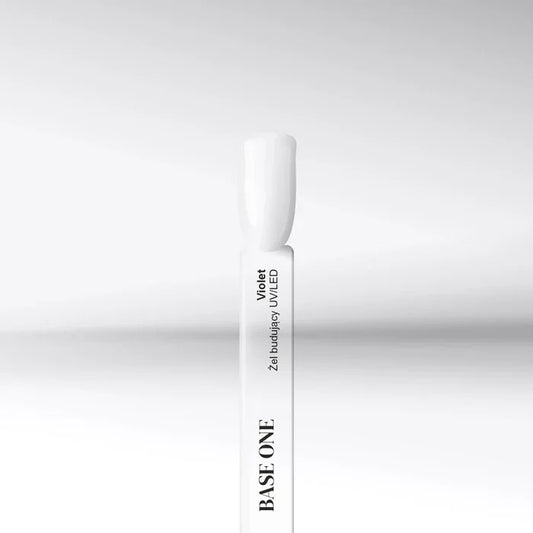 Cured nail tip displaying the transparent, high-gloss finish of the Base One Violet UV building gel (15g), used to prevent yellowing.