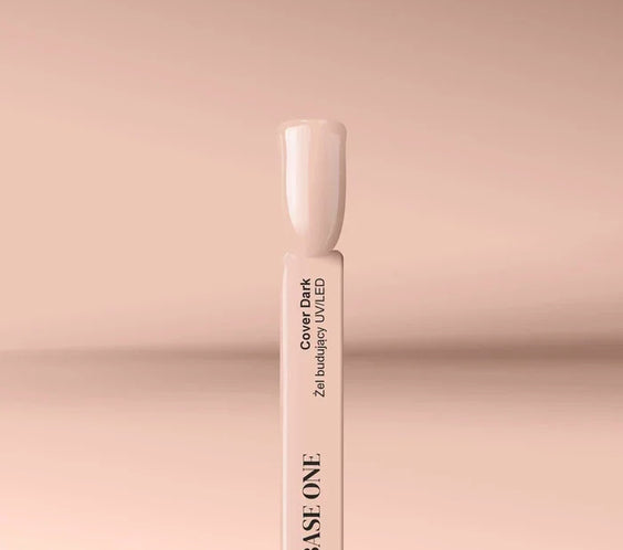 Applying the self-leveling Base One Cover Dark UV building gel (15g) onto a clear nail tip for a deep beige nail extension.
