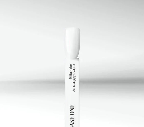 Cured nail tip displaying the opaque, milky white color of the Base One Milkshake UV builder gel (15g), perfect for a natural finish.
