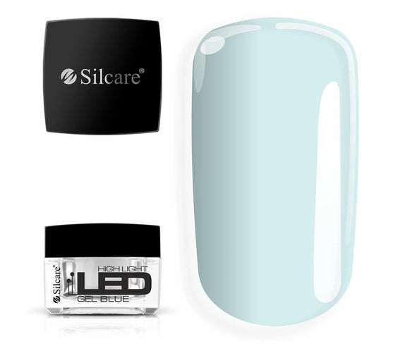 Jar of High Light LED Blue Builder Gel (15g), set next to a large nail tip, displaying the clear formula with a subtle blue tint to neutralize yellowing.