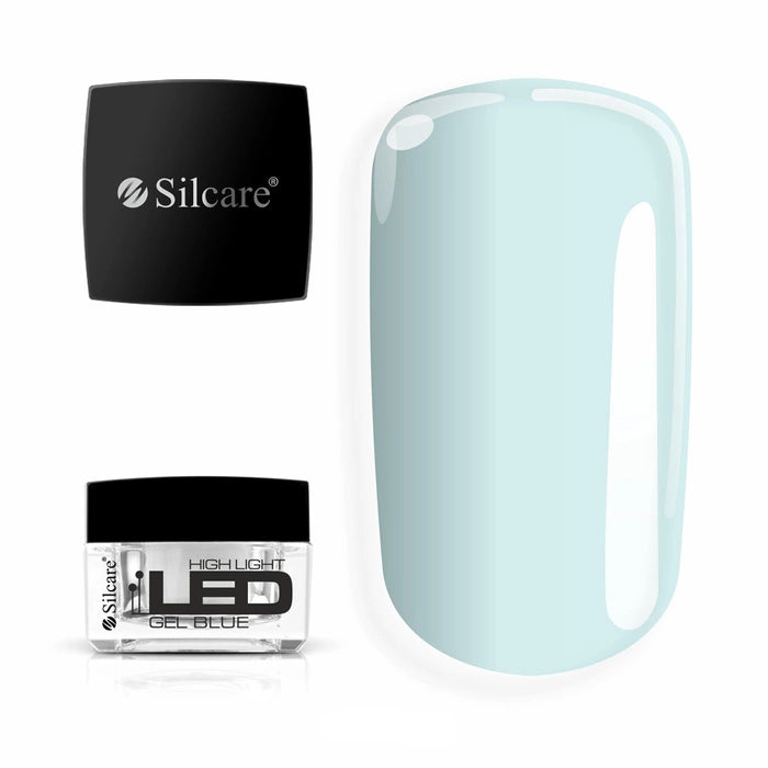 Jar of High Light LED Blue Builder Gel (15g), set next to a large nail tip, displaying the clear formula with a subtle blue tint to neutralize yellowing.