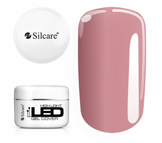 Jar of High Light LED Cover Builder Gel (100g), set next to a nail tip, displaying the opaque, natural nude pink color for nail bed extensions.