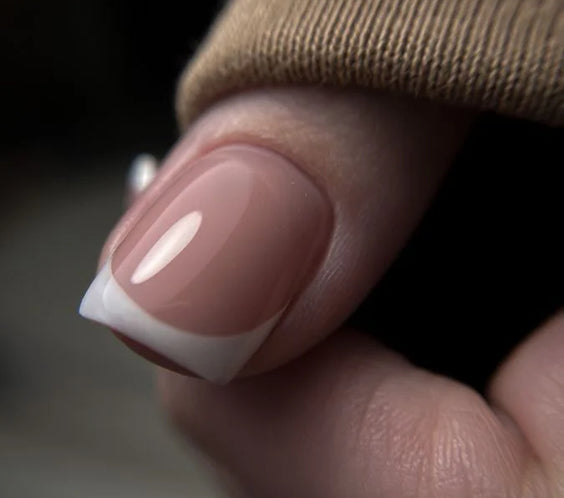 French manicure displaying the nail bed sculpted with High Light LED Cover Builder Gel, showing the opaque, natural nude pink coverage.