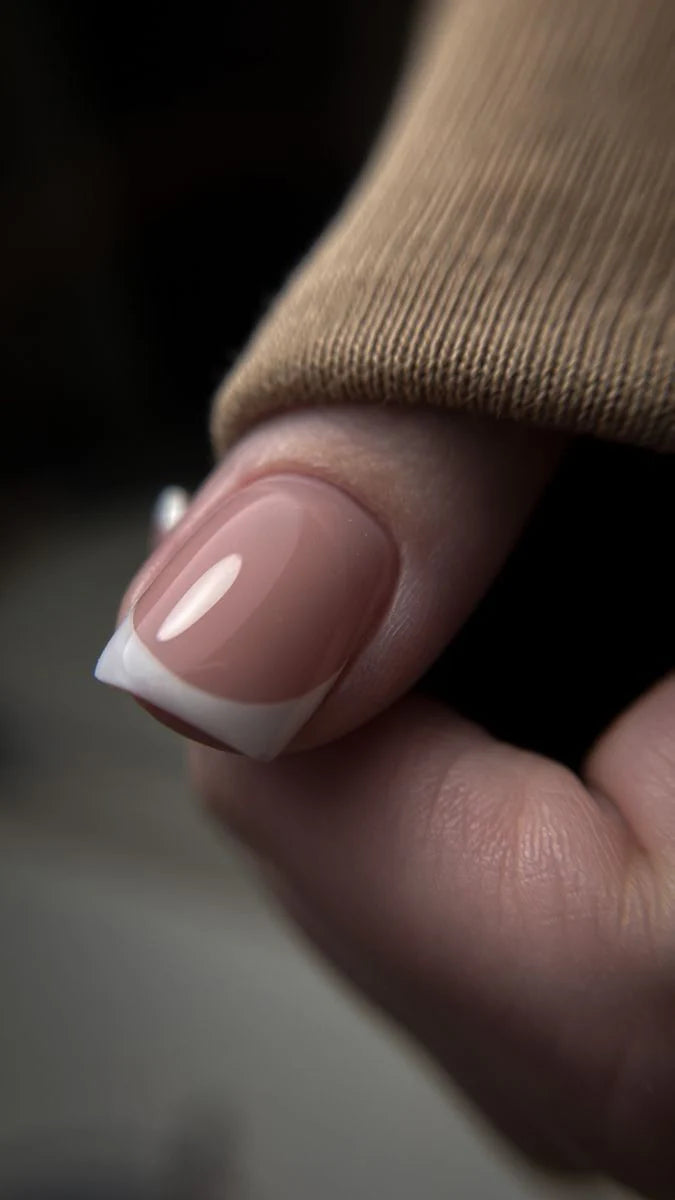 French manicure displaying the nail bed sculpted with High Light LED Cover Builder Gel, showing the opaque, natural nude pink coverage.