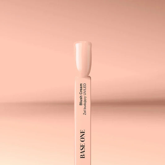 Cured nail tip displaying the opaque, natural beige color of the Base One Blush Cream UV builder gel (15g), perfect for a flawless camouflage manicure.