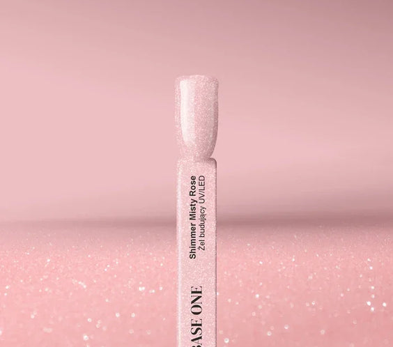 Cured nail tip displaying the opaque, dusty rose color of the Base One Shimmer Misty Rose builder gel (15g), finished with subtle, sparkling shimmer.