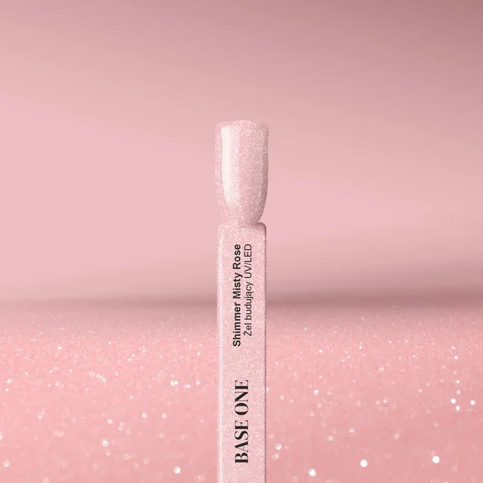 Cured nail tip displaying the opaque, dusty rose color of the Base One Shimmer Misty Rose builder gel (15g), finished with subtle, sparkling shimmer.