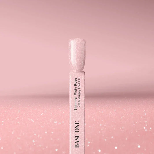 Cured nail tip displaying the opaque, dusty rose color of the Base One Shimmer Misty Rose builder gel (15g), finished with subtle, sparkling shimmer.