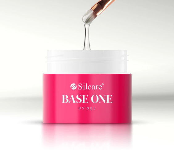 An open pink jar showing the medium-thick white consistency of French White Marble UV/LED builder gel on a brush by Silcare.