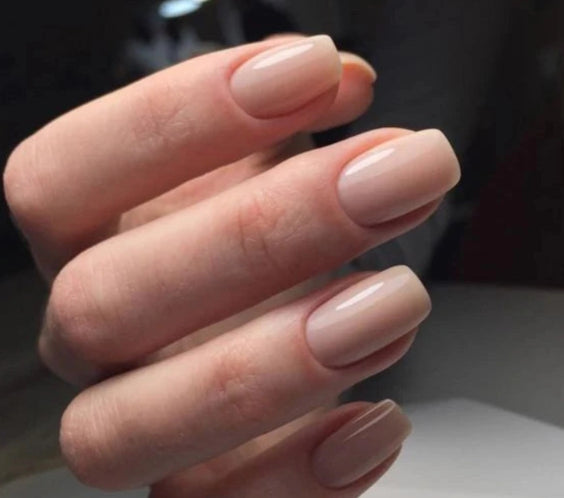 Natural manicure created with Silcare Brush One Naked Ambition bottle UV gel, featuring glossy nude pink BIAB nails with a soft milky finish on short square nails, ideal for nail strengthening, overlays and elegant everyday wear.