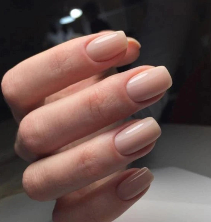 Natural manicure created with Silcare Brush One Naked Ambition bottle UV gel, featuring glossy nude pink BIAB nails with a soft milky finish on short square nails, ideal for nail strengthening, overlays and elegant everyday wear.