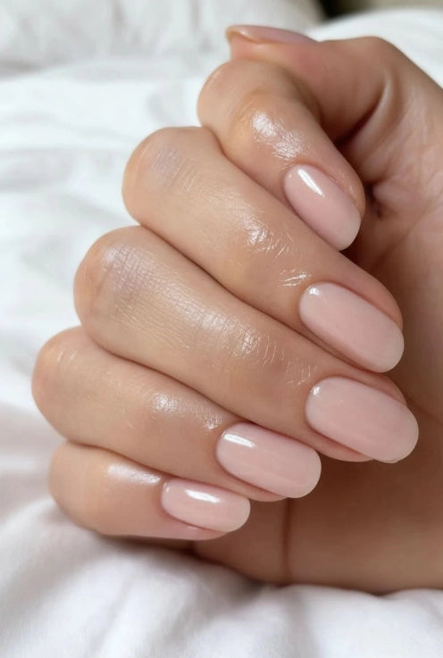 Elegant almond-shaped nails finished with Silcare Brush One Ash Blush BIAB bottle gel in a soft dusty blush pink nude shade. Glossy natural manicure with a smooth self-levelling finish, ideal for nail strengthening, overlays and professional salon-quality results.
