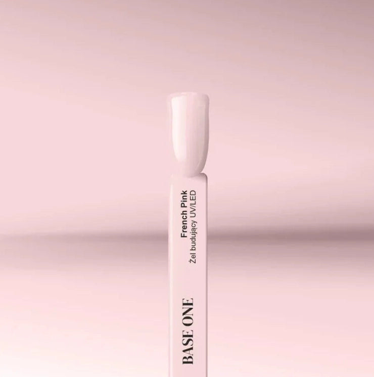 French Pink Silcare Base One Builder UV/LED Gel swatch stick displaying a soft pale pink nail shade, photographed on a pastel pink background with clean minimal product styling.