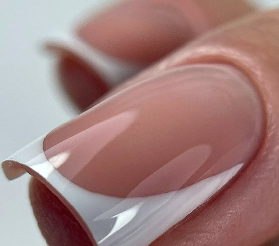 Close-up of a square-shaped French manicure featuring a crisp white tip and a soft pink marble base using Silcare professional nail products.