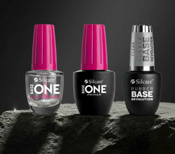 Professional Silcare nail system featuring Base One Nail Prep, Acid-Free Primer, and Clear Rubber Base bottles together, offering zero-lifting technology and superior adhesion for long-lasting manicures.