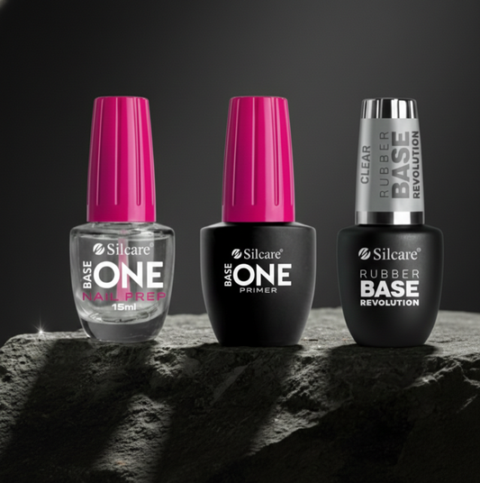 Professional Silcare nail system featuring Base One Nail Prep, Acid-Free Primer, and Clear Rubber Base bottles together, offering zero-lifting technology and superior adhesion for long-lasting manicures.