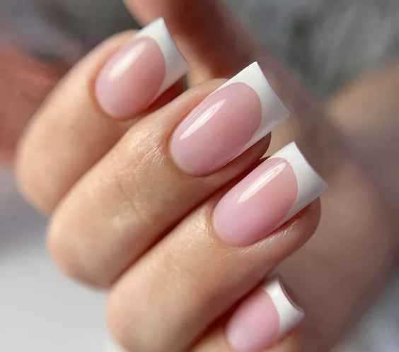 A high-gloss professional manicure using French White Opal Base One UV builder gel for a smooth, opaque white finish by Silcare.