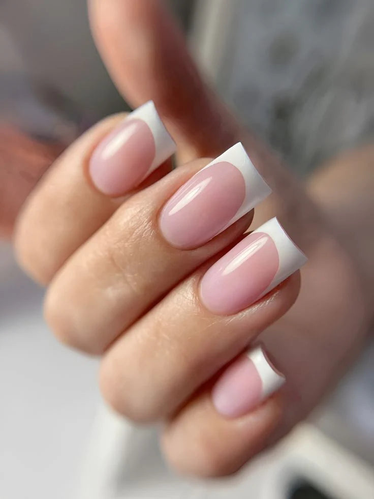 A high-gloss professional manicure using French White Opal Base One UV builder gel for a smooth, opaque white finish by Silcare.