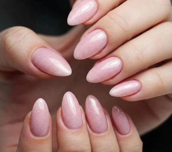 Shimmer Misty Rose Silcare builder gel manicure on almond-shaped nails with glossy finish, showing soft rosy pink colour with fine shimmer particles, close-up of both hands highlighting smooth application and elegant sparkling effect.