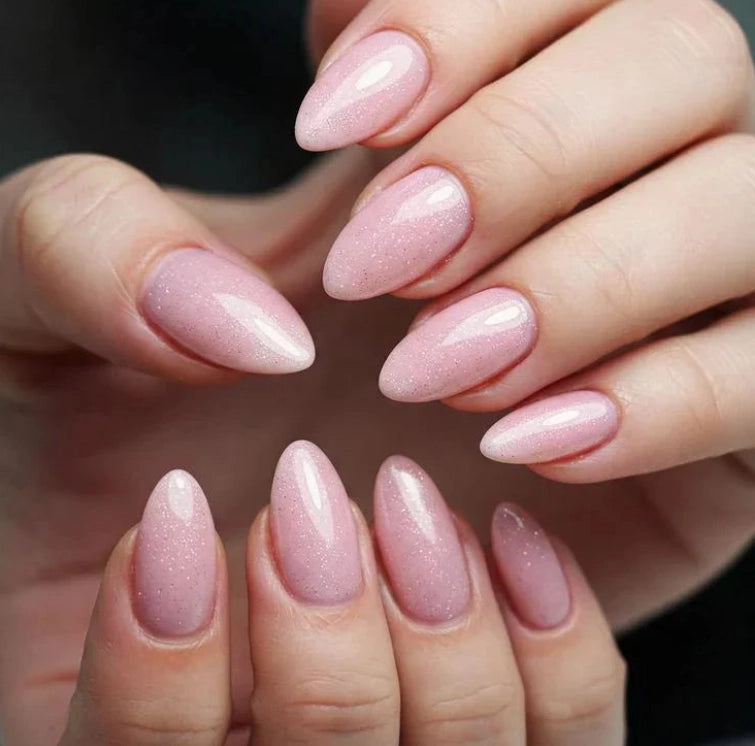 Shimmer Misty Rose Silcare builder gel manicure on almond-shaped nails with glossy finish, showing soft rosy pink colour with fine shimmer particles, close-up of both hands highlighting smooth application and elegant sparkling effect.
