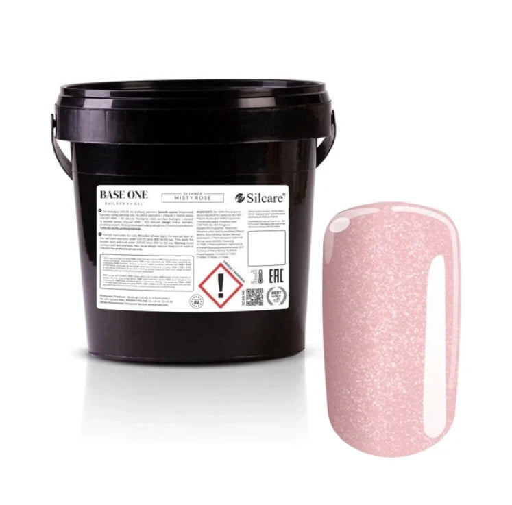 Shimmer Misty Rose Silcare Base One Builder Gel bulk salon bucket packaging with product label, shown next to a glossy nail swatch displaying soft rosy pink colour with fine shimmer, isolated on a clean light background for professional nail supply presentation.