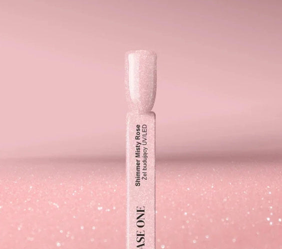 Shimmer Misty Rose Silcare Base One Builder UV/LED Gel swatch stick displaying a soft rosy pink shade with fine glitter shimmer, set against a matching sparkling pink background, highlighting glossy finish and delicate shimmer effect.