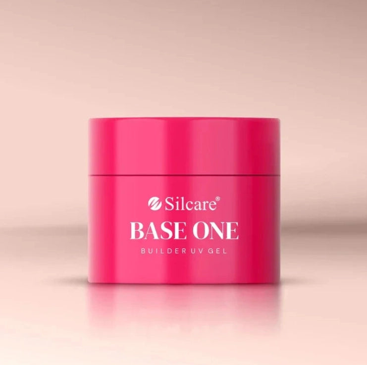 Silcare Base One Builder Gel Cover Light in bright pink jar packaging, photographed on a soft neutral background with clean studio lighting, showcasing professional nail builder gel product for natural-looking nail coverage.