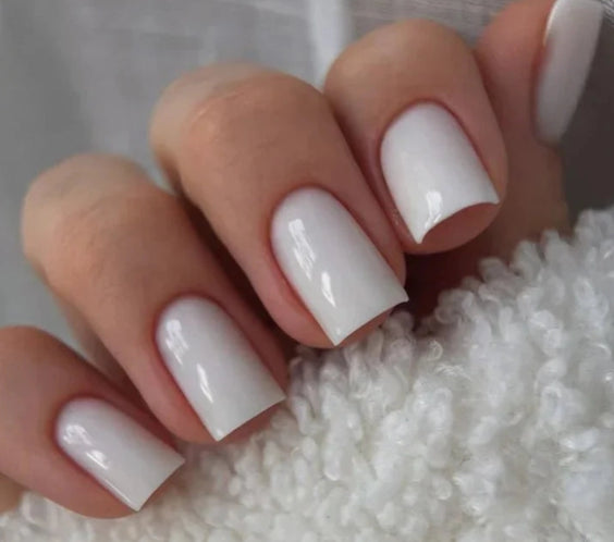 Silcare Base One Builder Gel Milkshake on short square nails, showcasing a glossy milky white manicure with full coverage, smooth self-levelling finish and professional UV LED builder gel for elegant nail overlays and extensions.