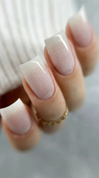 Close-up of elegant square-shaped nails finished with Silcare Base One Shimmer Milkshake builder gel, featuring a milky white shimmer, glossy salon-quality finish and delicate light-reflecting sparkle for a natural, sophisticated manicure – Silcare Australia.