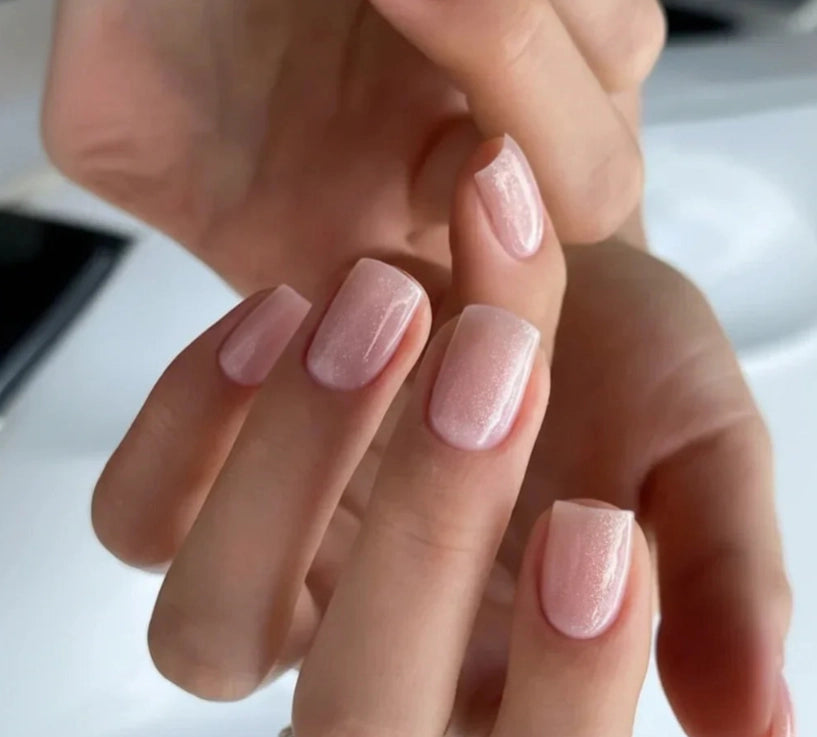 Close-up of short square-shaped nails finished with Silcare Base One Shimmer Vanillia Rose builder gel, featuring a soft milky blush pink shimmer, fine light-reflecting sparkle and a glossy self-levelling salon-quality finish for elegant natural-looking nails – Silcare Australia.