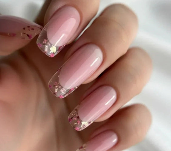 Silcare Base One Violet clear builder gel manicure with nude pink base and clear French tips decorated with flower glitter, long square glossy nails with encapsulated design