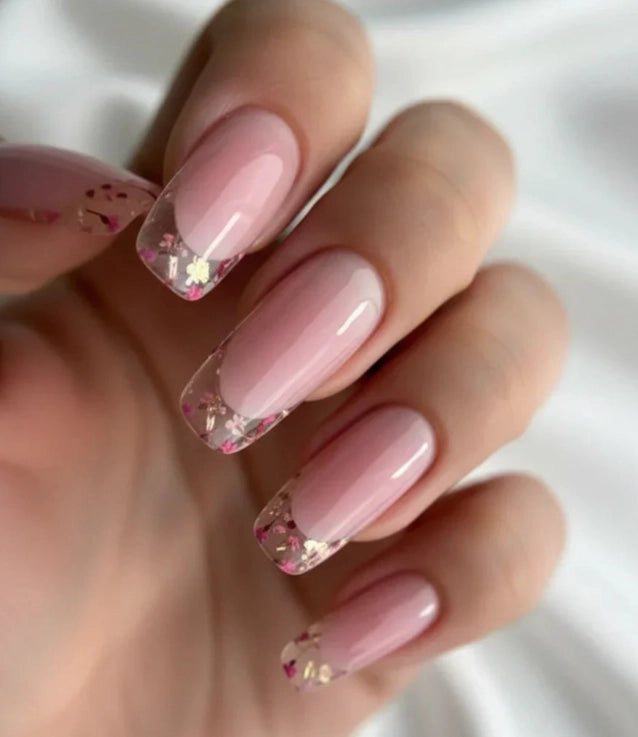 Silcare Base One Violet clear builder gel manicure with nude pink base and clear French tips decorated with flower glitter, long square glossy nails with encapsulated design