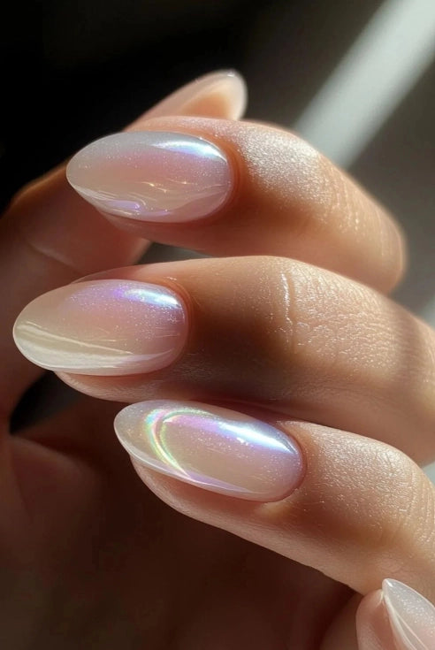 Close-up of almond-shaped nails finished with Silcare High Light LED Milky Aura UV/LED builder gel, showcasing a translucent milky white base with luminous pink, blue and pearl iridescent aura reflections in natural light. Elegant salon-quality nail extensions with a smooth glossy finish – Silcare Australia.