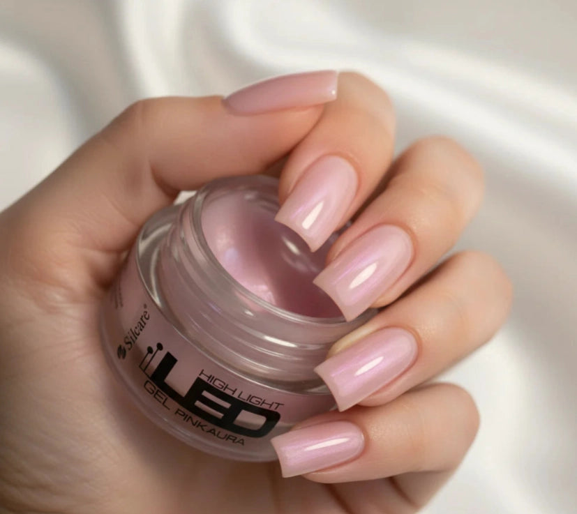 Close-up of elegant square nails created with Silcare High Light LED Pink Aura builder gel, featuring a translucent milky pink finish with luminous iridescent pearl shimmer while holding the High Light LED Pink Aura UV/LED builder gel jar – Silcare Australia.