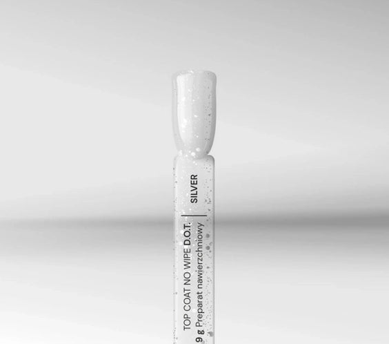 Close-up of Silcare silver no wipe gel top coat bottle and brush tip with fine glitter particles on a neutral background, showing glossy UV LED nail finish