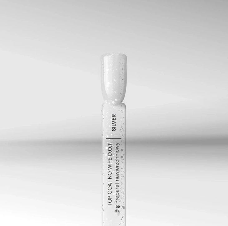 Close-up of Silcare silver no wipe gel top coat bottle and brush tip with fine glitter particles on a neutral background, showing glossy UV LED nail finish